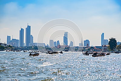 Long-tail boats in Chao Phraya river in Bangkok, Thailand. Tourist And Thai People Traveling By Boat Editorial Stock Photo