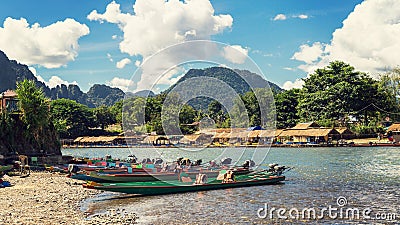 Long tail boats on sunset at Song river, Vang Vieng, Laos. Stock Photo