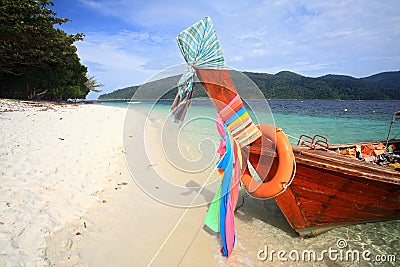 Long tail wooden boat with colorful ribbons Stock Photo