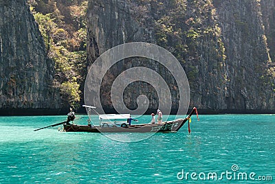 Classic Thai longtail boat in the lagoon of Phi Ley Editorial Stock Photo