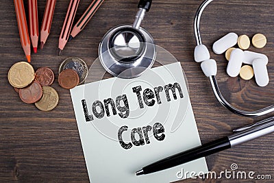 Long term care concept. Desk with stetascope, money and tablets. background for medical care Stock Photo