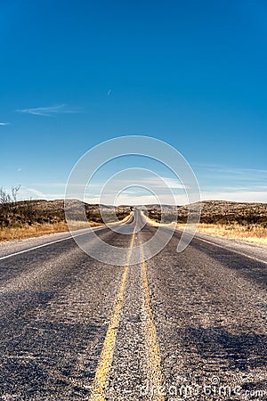 Long Texas Road disappearing into horizon Stock Photo