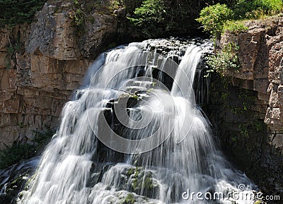 Long Time Exposure Of Flowing Water At The Rustic Falls Waterfall In Yellowstone National Park Stock Photo