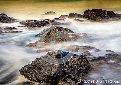 Long time exposure of waves around rocks at the Wild Coast at th Stock Photo