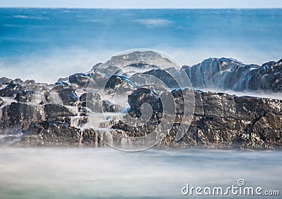 Long time exposure of waves around rocks at the Wild Coast at th Stock Photo