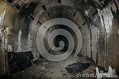 Long underground tunnel or corridor in abandoned Soviet military bunker or basement with creepy atmosphere Stock Photo