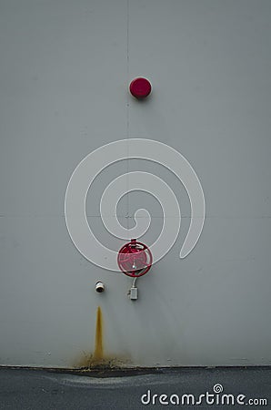 A long view of the red fire bell on the white wall Stock Photo