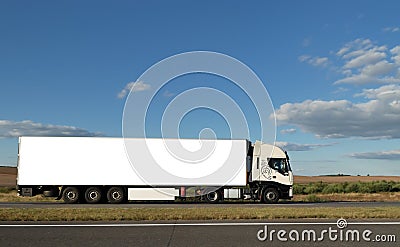 Long white truck on highway Stock Photo