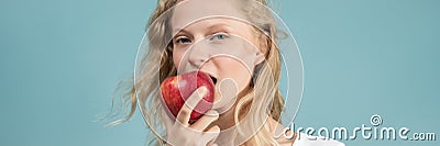 Long width banner with portrait of young woman bitting apple. Fresh face, natural beauty, Stock Photo