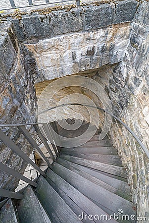 Long and winding wooden staircase inside a massive stone city wall outer defense Editorial Stock Photo
