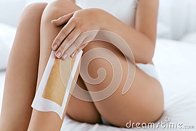 Long Woman Legs With Hair Wax Strip Closeup. Hair Removal Stock Photo