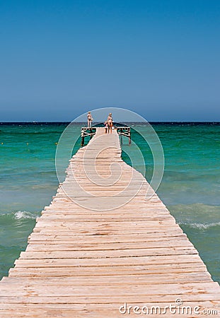 Long wooden jetty at Playa de Muro beach in Alcudia bay Editorial Stock Photo