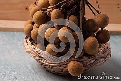 Longan basket in bamboo, black background Stock Photo