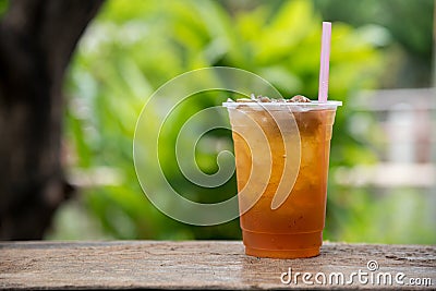Longan juice in plastic glass with green leaf natural background Stock Photo