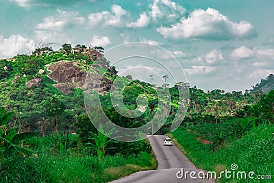 Automobile on a longer section of a disappearing rural road Ekiti State Nigeria. Disappearing road Stock Photo