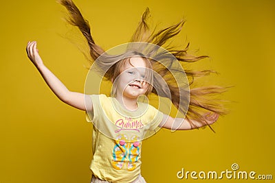 Longhaired girl in cute shirt playing with hair and twirling Stock Photo