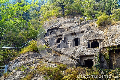 Longmen Grottoes with Buddha`s figures are Starting with the Northern Wei Dynasty in 493 AD. It is one of the four notable Stock Photo