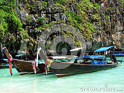 Longtale boats at the Phuket beach with limestone rock on background in Thailand. Phuket island is a most popular tourist destinat Editorial Stock Photo