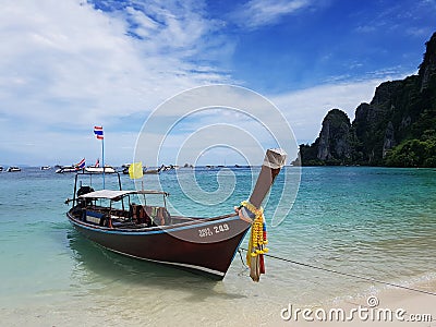 Longtale Thai taxi boat on white sand sea beach and blue sky Editorial Stock Photo