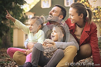 Look Daddy , daughter showing something to sister. Stock Photo