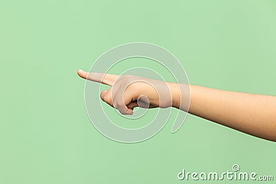 Look this! Hand finger pointing isolated on green background. Stock Photo
