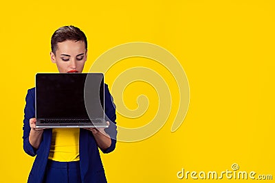 Look here. Closeup portrait curious serious businesswoman corporate employee holding computer looking at screen peering peeking Stock Photo