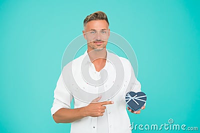 Look here. Handsome man buy gift for girlfriend. Valentines day shopping. Happy holiday celebration. Heart gift box Stock Photo