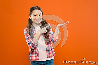 Look here. happy child. happy childrens day. childhood memory. small girl orange background. kid fashion. smiling school Stock Photo