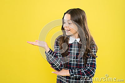 Look here. Product presentation. Small girl nice hairstyle. Child long curly hair. Happy schoolgirl stylish uniform Stock Photo