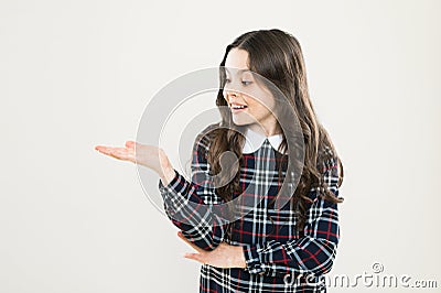 Look here. Product presentation. Small girl nice hairstyle. Child long curly hair. Happy schoolgirl stylish uniform Stock Photo