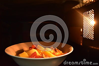 Look inside the microwave food white bowl, In a warm atmosphere and empty top space for text. Stock Photo