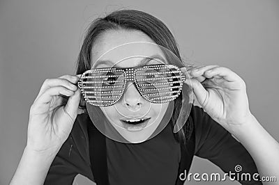 Look with interest. Eyewear fashion shop. Party accessory. Having fun. Carnival party. Kid and striped eyeglasses. Girl Stock Photo