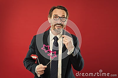 Look smarter. Man holds party props eyeglasses. Boss or businessman wear formal suit posing party accessory. Business Stock Photo