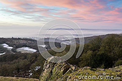 Looking across the English countryside on a winters sunrise, with mist lying in the valley below. From Raggedstone Hill on the Mal Stock Photo