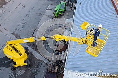 Looking down on woman in cherry picker Stock Photo