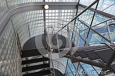 Looking downwards in an open stairwell of a modern building Stock Photo