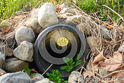 Looking Through a French Drain With a Black Pipe and Rocks Surrounded it Stock Photo