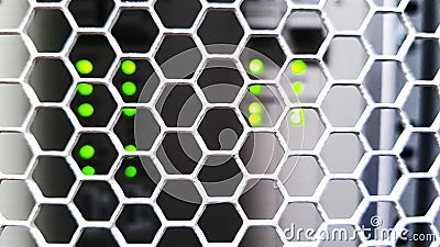 Looking through honeycomb pattern doors inside modern big data server rack in the data center with network servers hardware Stock Photo