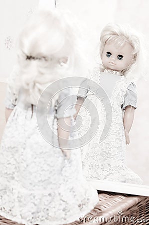 Looking for identity - vintage doll at the mirror Stock Photo