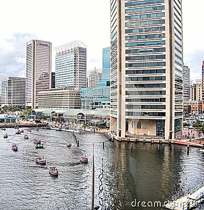 Looking Out Over the Baltimore Inner Harbor Where Tourists Ride in Pirate Themed Paddle Boats Editorial Stock Photo