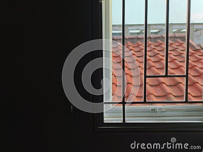 Looking out the window of a dark room... Stock Photo