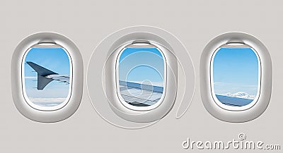 Looking out the windows of a plane to the aircraft wing and clou Stock Photo