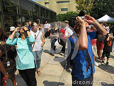 Looking at the Partial Solar Eclipse Editorial Stock Photo