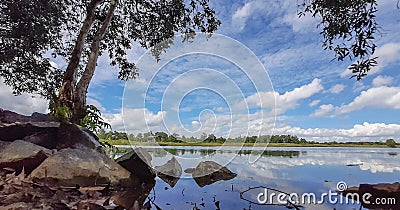 looking at the reflection of Lake Seran which is very calm and beautiful Stock Photo