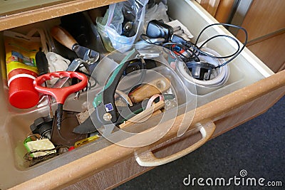 Looking into a untidy drawer. Messy drawer with tools, household items and various other objects Stock Photo
