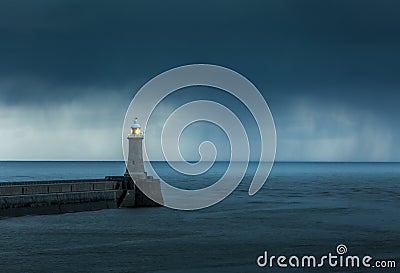 Looking up the River Tyne out to the North Sea at dawn, as large grey rain clouds loom over the Piers Stock Photo