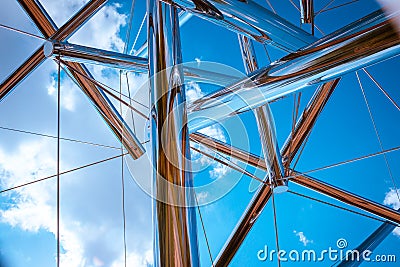 Looking up at the sky through a chrome statue Stock Photo