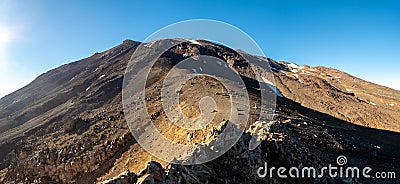 Looking up at the summit of Mount ruapehu in summer with light snow Stock Photo