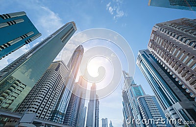 Looking up to high-rise office buildings, skyscrapers, architectures in financial district with blue sky. Smart urban city for Editorial Stock Photo