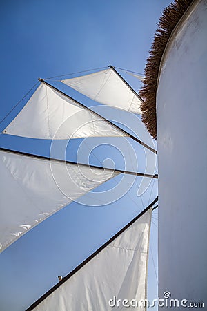 Greek Windmill sails against azure blue sky Stock Photo